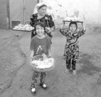 A smiling family taking food to the market — a typical, and delightful, scene in Central Asia.