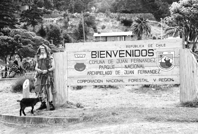 “Robinson Crusoe” beside the island’s welcome sign.