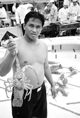 An M.V. Discovery crewman holds up a Robinson Crusoe Island sea crayfish.