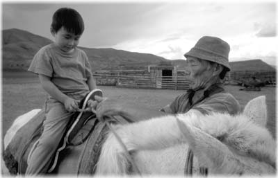 Grandfather and grandson prepare for a ride.