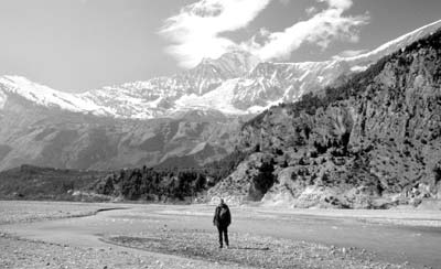 Steven Cole in the bed of the Kali Gandaki with 26,810-foot Mount Dhaulagiri in the background.