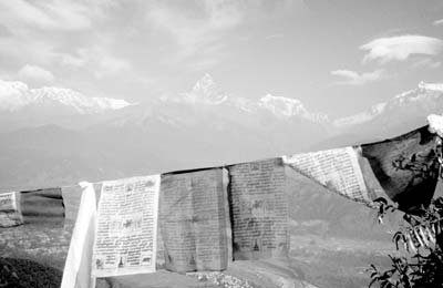 Buddhist prayer flags frame the Annapurna range, as seen from Sarangkot.