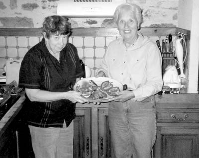 Catherine Grisé (left) and Lorna Tjaden, in Catherine’s kitchen, with red peppers stuffed with fennel — Issepts, France.