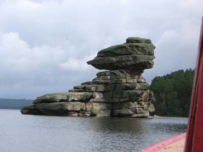 The sphinx-like rock known as Three Sisters rises from the water of the Blue Gulf of Borovoye.