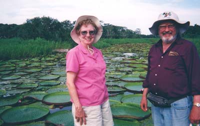 Emilee Hines and husband, Fred Blackwell, stand beside giant lily pads.