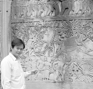 Guide Lin explaining wall engravings at Angkor Thom. Photo: Keck