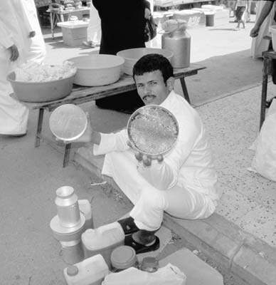 Honey salesman at a market in Riyadh.