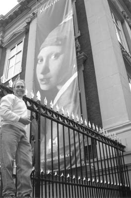 Rob Kane and a banner of Vermeer’s “Girl with a Pearl Earring” — Mauritshuis.