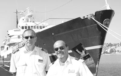Captain Zlatko Pazanin (left) and Hotel Manager Sergio Calabrese beside their ship, M.S. Andrea, of Elegant Cruises. Photos: Toulmin