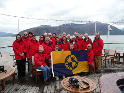 Aboard the Spirit of Adventure sailing through the Strait of Magellan, the “Smithies” display the Smithsonian flag.