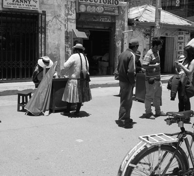 A money changer does a brisk business at her desk in the town of Desaguadero, where we crossed from Peru into Bolivia.
