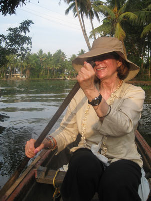 Here I am in a canoe  in Kerala ’s backwater, paddling down stunning, palm-fringed lanes bordered by houses.