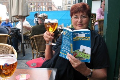 Tressie at a café in Bruges with the Rick Steves guidebook. Photos: Alvernaz