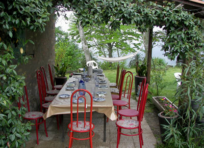 A table is set for our lunch under a grape arbor at an herb farm in Modigliano.