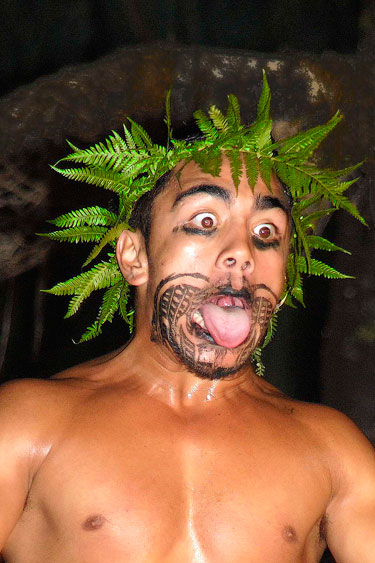 Pictured here with a crown of ferns is a young Maori performing a haka (war dance) at the Mitai Maori Village.