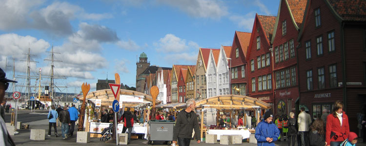 The World Heritage port of Bergen features cobbled streets, wooden houses, a signature fish market and seasonal markets for regional foods.
