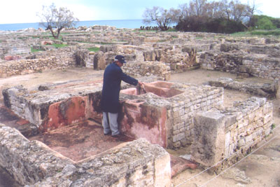 Our guide, Hammadi, pointing out the red bathtub in a Punic-era house in Kerkouane. Photos: Skurdenis