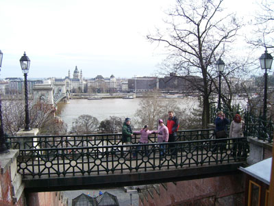 The Danube forms the background for a walkway above the Buda side of the Chain Bridge, providing a panoramic view of Pest.