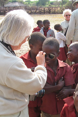 A student at Ngamo School in Zimbabwe peers through Wanda Bahde’s sunglasses.   Photo by Ray Bahde