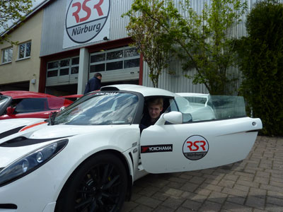 Ryan sitting in the driver’s seat of a 2010 Lotus Exige in the RSR Nürburg parking lot before the Lotus Road Rally.