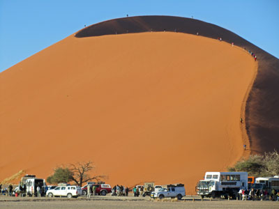 Many visitors enjoy climbing the massive sand dunes in Namibia.