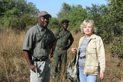Regine with guide, Gilbert, and a ranger on a walking safari at Kuyenda Bush Camp.