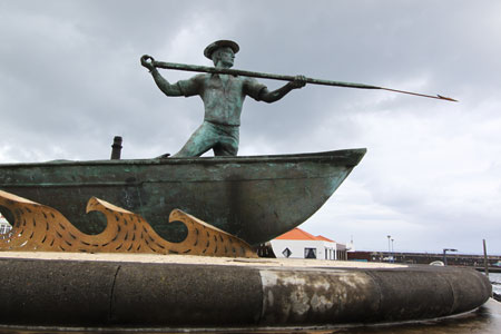 The statue of a whaler outside the Museu da Indústria Baleeira in São Roque, Pico, Azores, Portugal