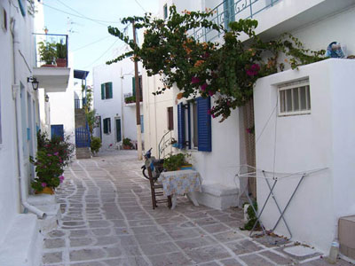 Whitewashed buildings line a lane on the island of Paros.