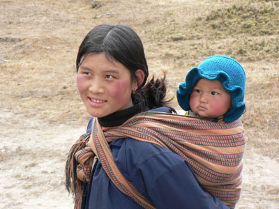 A local woman carrying her baby in the typical Bhutanese way. 
