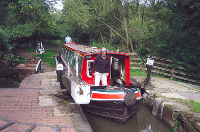 Margaret Chavez on the bow of the Kenilworth Castle with Bill Timms at the helm as we enter a lock.