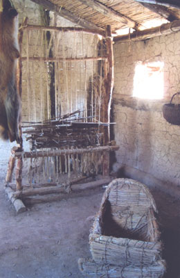 A loom and baby cradle inside one of the houses at the Bay of Bones.