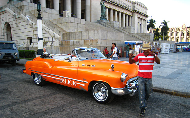 Many visitors equate Cuba with vintage American cars, which were brought to the island before Fidel Castro seized power in 1959. Many, like this one, are used as taxis. Photo by Tom Auciello
