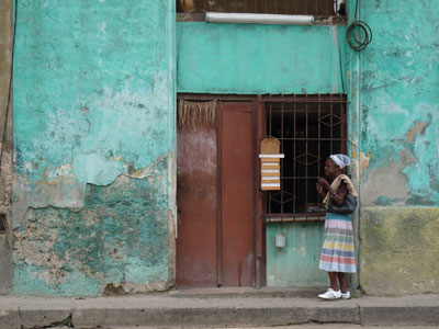 A woman passing a store in Centro Habana.