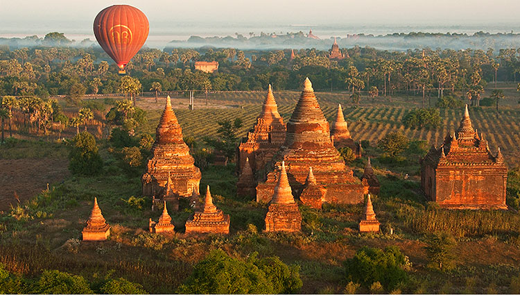 A hot-air balloon floats over pagodas in Bagan.