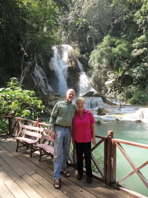 Colin Brodie wearing an L.L.Bean sun shirt and Ethel Brodie wearing Chico’s Travelers slacks at Kuang Si Falls, Laos.