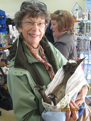 Anne Adams Helms holding a joey (baby kangaroo).