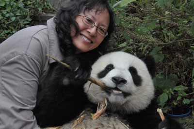 Gail Newlin poses with a young panda. Photos by Gail and Richard Newlin