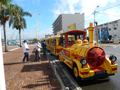 Visitors from the Volendam boarding the Yellow Tchou Tchou Train for a 2-hour tour of Nouméa.