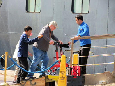 Crew members assisted a passenger and his wife reboarding the Prinsendam in Morocco.