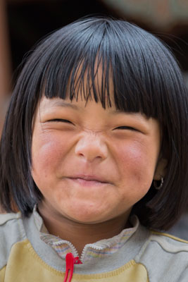 A smiling young girl encountered on a temple visit.