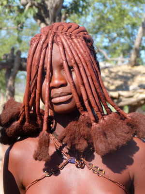 A Himba woman in Damaraland, Namibia, displaying a traditional hairstyle of the tribe.