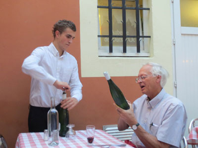 George Nevin and a waiter discuss the wine for dinner in Carcassonne.