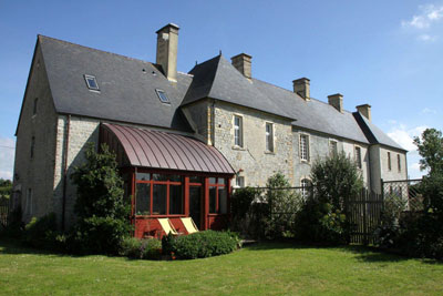 View of Château de Brix from the back garden. The wing with skylights and sunroom is the 3-story gîte. Photos by Paula Prindle<br />
