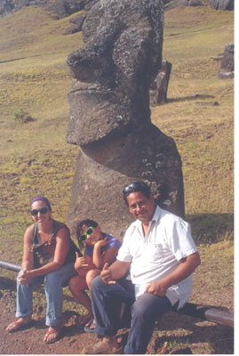 Sitting in front of a moai are guide Leo Pakarati (right), his wife, Paula, and, between them, their daughter, Mykaela — Easter Island. Photos by Anita Ream<br />
