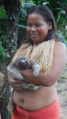 A woman from the Yagua tribe holding a baby sloth.