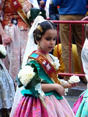 A child participates in the Offering of Flowers.