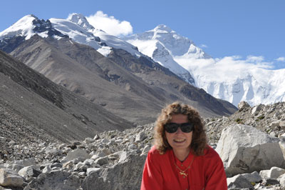 Emmy at 18,000 feet, with Mount Everest in the background towering above the clouds.