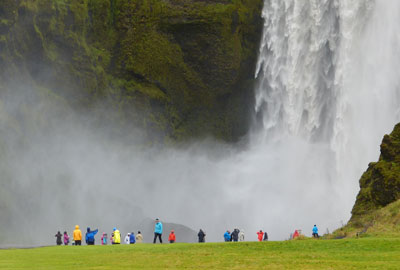Seljalandsfoss drops a whopping 200 feet from the rocky cliff above.