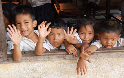Waving schoolchildren in Koh Oknha Tey, Cambodia.