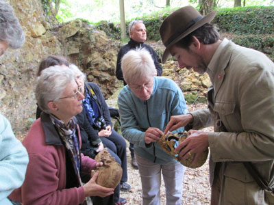 Group members and archaeologist Ian Morley looking at reproductions of Neanderthal skulls. Photo by Joanne Kuzma